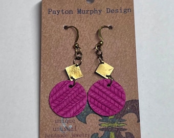May include: A pair of pink leather earrings with gold square accents and brass hooks. The earrings are displayed on a card that reads "Payton Murphy Design, unique unusual handmade jewelry".
