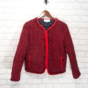May include: Red and black tweed jacket with a zipper closure and frayed edges. The jacket has two pockets on the front.