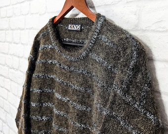 May include: A brown and silver striped sweater with the word "ESCADA" on the label.