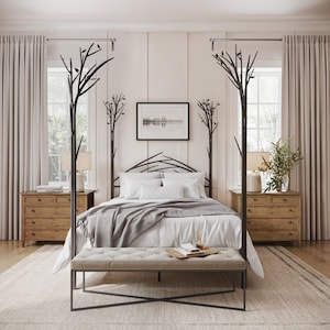 May include: A black metal canopy bed frame with a tree branch design. The bed has a white duvet, gray throw blanket, and white pillows. Two matching wooden nightstands with drawers are on either side of the bed.