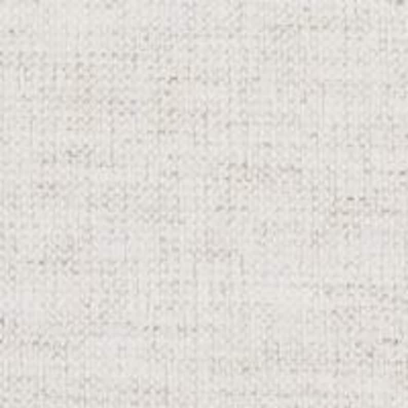 Light-colored fabric for an iron canopy bed upholstered headboard.
