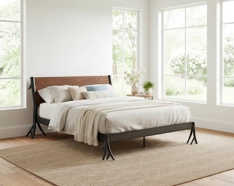 May include: A modern bed frame with a dark metal base and a wooden headboard. The bed is made up with white bedding, pillows, and a beige throw blanket. The room has large windows and a beige rug.