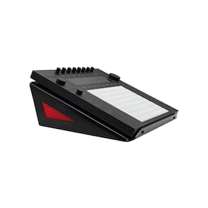 May include: Black electronic music production controller with a grid of white pads, knobs, and buttons. The angled base has a red accent. This digital audio workstation (DAW) controller is designed for music creation and performance.