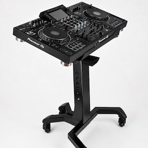 May include: A black Pioneer DJ controller on a black stand with the word "Apache" on the stand. The controller has multiple knobs, buttons, and two circular platters. The stand has four wheels.