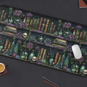 May include: A dark green and purple mousepad with a bookshelf design. The bookshelf is filled with books, potion bottles, skulls, and flowers. The mousepad is perfect for gamers and anyone who wants to add a touch of whimsy to their desk.