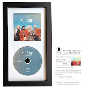 May include: A framed, signed CD insert and CD of the song "Mr. Sun" by Little Big Town. The insert features a photo of the band members and their autographs. The CD is in a black frame with a white mount.