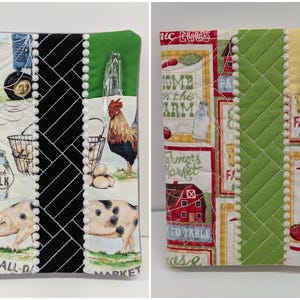 May include: Two quilted fabric notebook covers featuring farm-themed prints. The left cover displays a pig, rooster, and milk jug with black and green accents. The right cover shows red barns and farm text with yellow and green accents. Both include a pen.