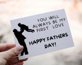 May include: A white card with black text and a silhouette of a father holding a child. The text reads "You will always be my first love Happy Fathers Day!"