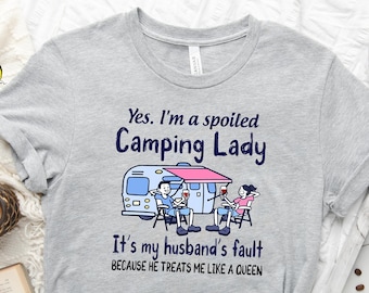 May include: Gray t-shirt with a graphic of a camper van and two people sitting outside. The text on the shirt reads "Yes. I'm a spoiled Camping Lady. It's my husband's fault because he treats me like a queen."