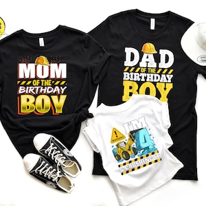May include: A set of three black and white t-shirts with construction-themed birthday graphics. The shirts say "Mom of the Birthday Boy", "Dad of the Birthday Boy", and "I'm 4 & Crushing It".