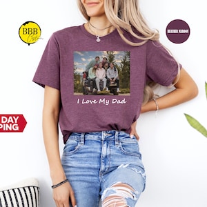 May include: A heather maroon t-shirt with a photo of a family in a truck bed. The text "I Love My Dad" is printed below the photo.