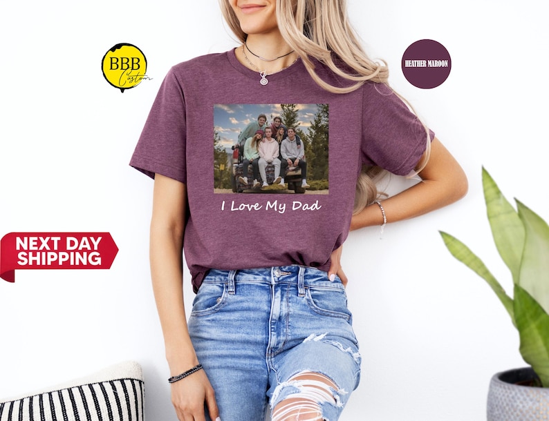 May include: A heather maroon t-shirt with a photo of a family in a truck bed. The text "I Love My Dad" is printed below the photo.