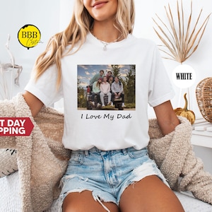 May include: White t-shirt with a photo of a family in a car and the text "I Love My Dad".