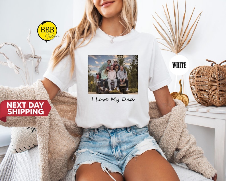 May include: White t-shirt with a photo of a family in a car and the text "I Love My Dad".