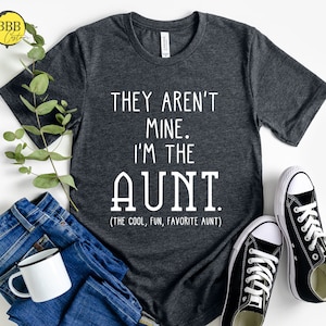 May include: A dark gray t-shirt with white text that reads "They aren't mine. I'm the AUNT (The cool, fun, favorite aunt)".