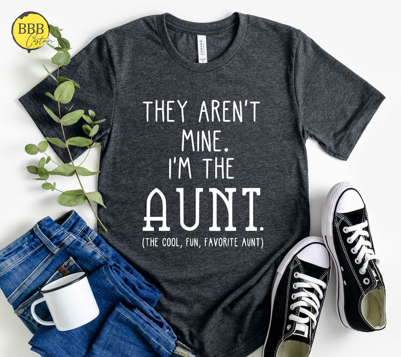 May include: A dark gray t-shirt with white text that reads "They aren't mine. I'm the AUNT (The cool, fun, favorite aunt)".
