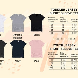 May include: A chart showing the size measurements for toddler and youth short sleeve jersey t-shirts. The chart includes the body width, body length, and size in inches. The chart is displayed against a background of various colored t-shirts.
