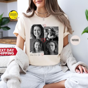 May include: A beige t-shirt with a collage of four black and white photos of women. The photos are arranged in a grid with a red heart in each corner. The text "Cause I Love You" is written below the photos.