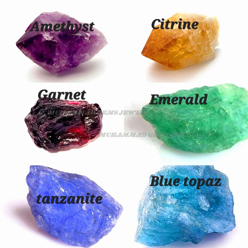 May include: An assortment of raw gemstones, including amethyst, citrine, garnet, emerald, tanzanite, and blue topaz. Each stone is labeled with its name in a clear, bold font. The gemstones display a variety of colors and textures, from deep purple to vibrant green.