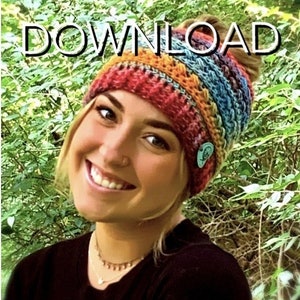 May include: A woman wearing a colorful crochet hat with a messy bun. The hat has a rainbow color scheme with stripes of red, orange, yellow, green, blue, and purple. The text "PDF DOWNLOAD" is superimposed on the image.