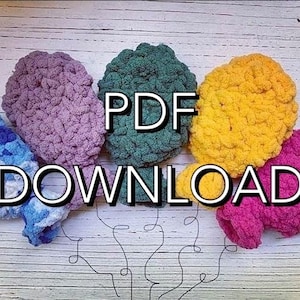 May include: Five crocheted hats in different colors, including blue, purple, green, yellow, and pink. The hats are arranged in a circle on a white wooden surface. The text "PDF DOWNLOAD" is written in black letters on the image.