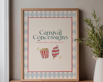 May include: A framed print with the words "Carnival Concessions" in green script. The print features illustrations of popcorn and cotton candy, with the text "PLEASE GRAB A PLATE AND ENJOY!" in a smaller font. The frame has a light wood finish.