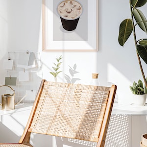 May include: A framed print of a minimalist illustration of an iced latte in a to-go cup. The text "ICED LATTE" is printed in brown letters at the top of the print.