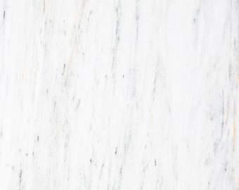 May include: White marble with subtle grey and orange veining. The marble has a smooth, polished surface.