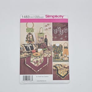 May include: Simplicity pattern 1483 featuring wine-themed accessories. The pattern includes instructions for a wine bottle tote, a table runner, and a kitchen towel with a decorative ring. The pattern is designed by Faith Van Zanten.