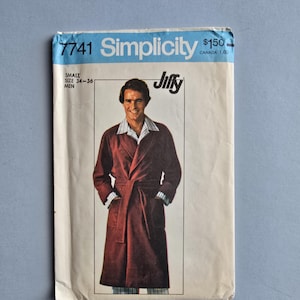 May include: Vintage Simplicity sewing pattern for a men's robe. The pattern envelope is off-white with the number 7741 and the word "Simplicity" in blue. The illustration shows a man wearing a burgundy robe with a belt.