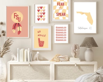May include: A set of eight printable wall art prints featuring a college sports theme. The prints feature a variety of designs, including a heart pattern, a state outline, a hand gesture, and text that says "Fear the Spear" and "Go Noles!" The prints are in a yellow and red color scheme.