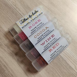 Four tinted tallow lip balm in four shades 'rose', 'cocoa', 'wine', and 'red'.  One clear lip balm with no added color.  Scented with peppermint and orange essential oil.