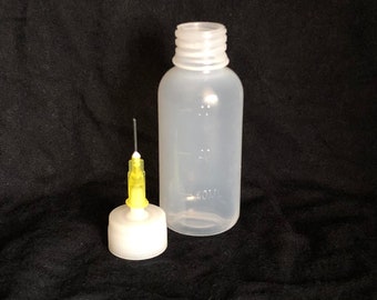 May include: A clear plastic bottle with a white cap and a yellow needle tip. The bottle is labeled "40mL".