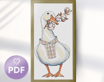 May include: Cross stitch pattern featuring a white goose wearing a blue and orange embroidered shirt, holding a sprig of white cotton.