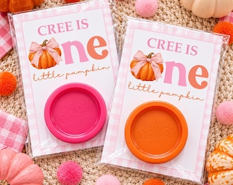 May include: Two rectangular cards in clear plastic sleeves, each featuring a pumpkin illustration with a pink bow, the text 'CREE IS one little pumpkin', and a circular Play-Doh lid attached, one in hot pink and one in bright orange.
