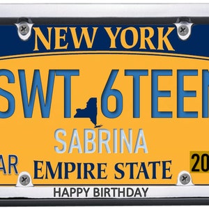 May include: A yellow and blue New York license plate with the text "SWT 16TEEN" and "SABRINA" in white. The plate also has the text "MAR EMPIRE STATE 2005" and "HAPPY BIRTHDAY" in black.