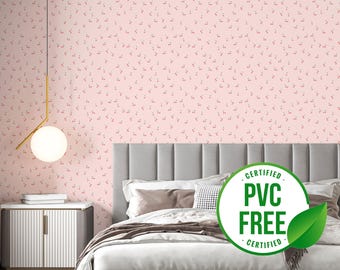 May include: A pink wallpaper with a small, repeating pattern of red dots. A bed with a gray headboard and white bedding is in front of the wallpaper. A green and white sticker with the text "CERTIFIED PVC FREE CERTIFIED" is on the bed.