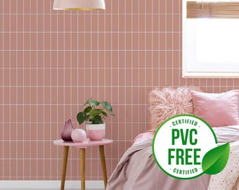 May include: A pink and white tiled wallpaper with a bed in the background. The bed has a pink fluffy throw pillow and a white and pink patterned blanket. A green leaf with the text "CERTIFIED PVC FREE CERTIFIED" is in the foreground.