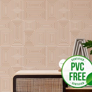 May include: A beige wallpaper with a white geometric pattern of overlapping squares and rectangles. A wooden shelf with a woven basket and a green plant in a glass vase is in front of the wallpaper. A white clock and a green and white circular sticker with the text "CERTIFIED PVC FREE CERTIFIED" are on the shelf.