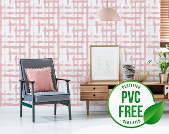 May include: A pink and white geometric patterned wallpaper with a grey armchair, a wooden side table, a framed print, and a green leaf with the text "CERTIFIED PVC FREE CERTIFIED" in a white circle.