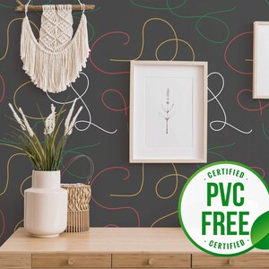 May include: Black and white abstract wallpaper with colorful lines and a green leaf sticker that says "Certified PVC Free Certified".