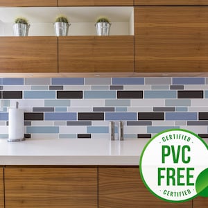 May include: A kitchen backsplash with a blue and black tile pattern. A white countertop with a white paper towel holder and two silver salt and pepper shakers. A green and white sticker with the text "CERTIFIED PVC FREE CERTIFIED" is in the foreground.