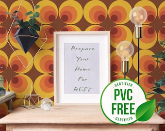 May include: A framed sign with the text "Prepare Your Home For Best" hangs on a wall with a retro 70s style wallpaper pattern in shades of orange, yellow, and brown. The wallpaper features a repeating pattern of concentric circles. Two light bulbs hang from the ceiling, and a potted plant sits on a shelf.