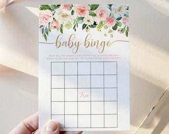 May include: A floral baby bingo card with a pink and white floral design. The card has a free space in the center and 24 other squares. The text "baby bingo" is written in gold cursive lettering at the top of the card.