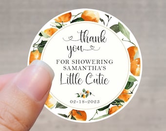 May include: Round white thank you sticker with orange citrus fruit illustrations and green leaves. The text reads "thank you for showering Samantha's Little Cutie 02-18-2023".
