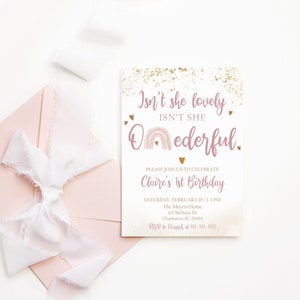 May include: Pink and gold birthday invitation with a rainbow and the text "Isn't she lovely, Isn't she Oederful."  The invitation is for Claire's 1st birthday party on Saturday, February 18th from 1-3 PM at The Meyers Home, 107 Birthday Dr, Charleston, SC 29464. RSVP to Haggard at 555-555-5555.