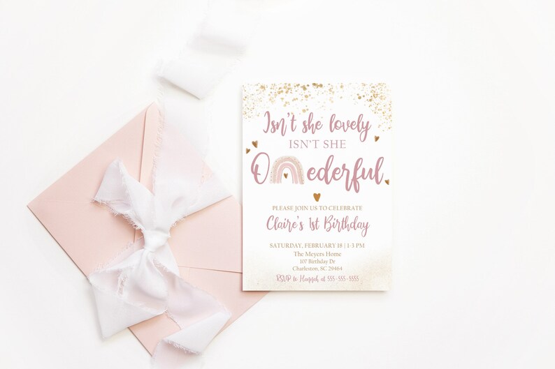 May include: Pink and gold birthday invitation with a rainbow and the text "Isn't she lovely, Isn't she Oederful."  The invitation is for Claire's 1st birthday party on Saturday, February 18th from 1-3 PM at The Meyers Home, 107 Birthday Dr, Charleston, SC 29464. RSVP to Haggard at 555-555-5555.