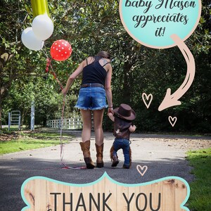 May include: A woman and a child in cowboy hats walk down a path with balloons. The text "Sweet baby Mason appreciates it!" is in a speech bubble above them. A wooden sign with the text "THANK YOU for supporting us!" is in the foreground.