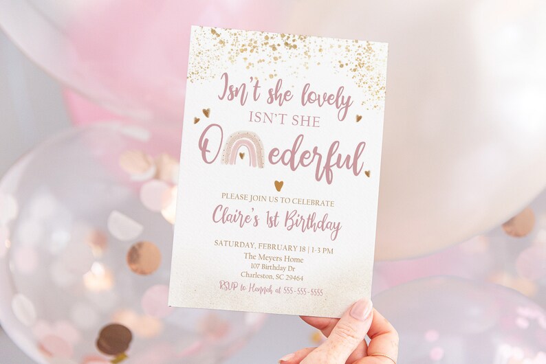 May include: A pink and gold birthday invitation with a rainbow and the text "Isn't she lovely, Isn't she O-nederful." The invitation is for Claire's 1st birthday party.