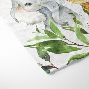 May include: Watercolor painting of a baby elephant and a baby giraffe with green leaves. The animals are painted in a light gray and light brown color.